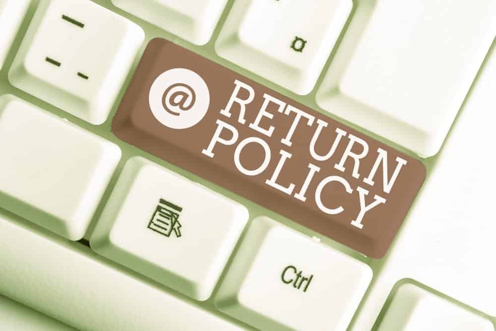 A keyboard with return policy written on it.