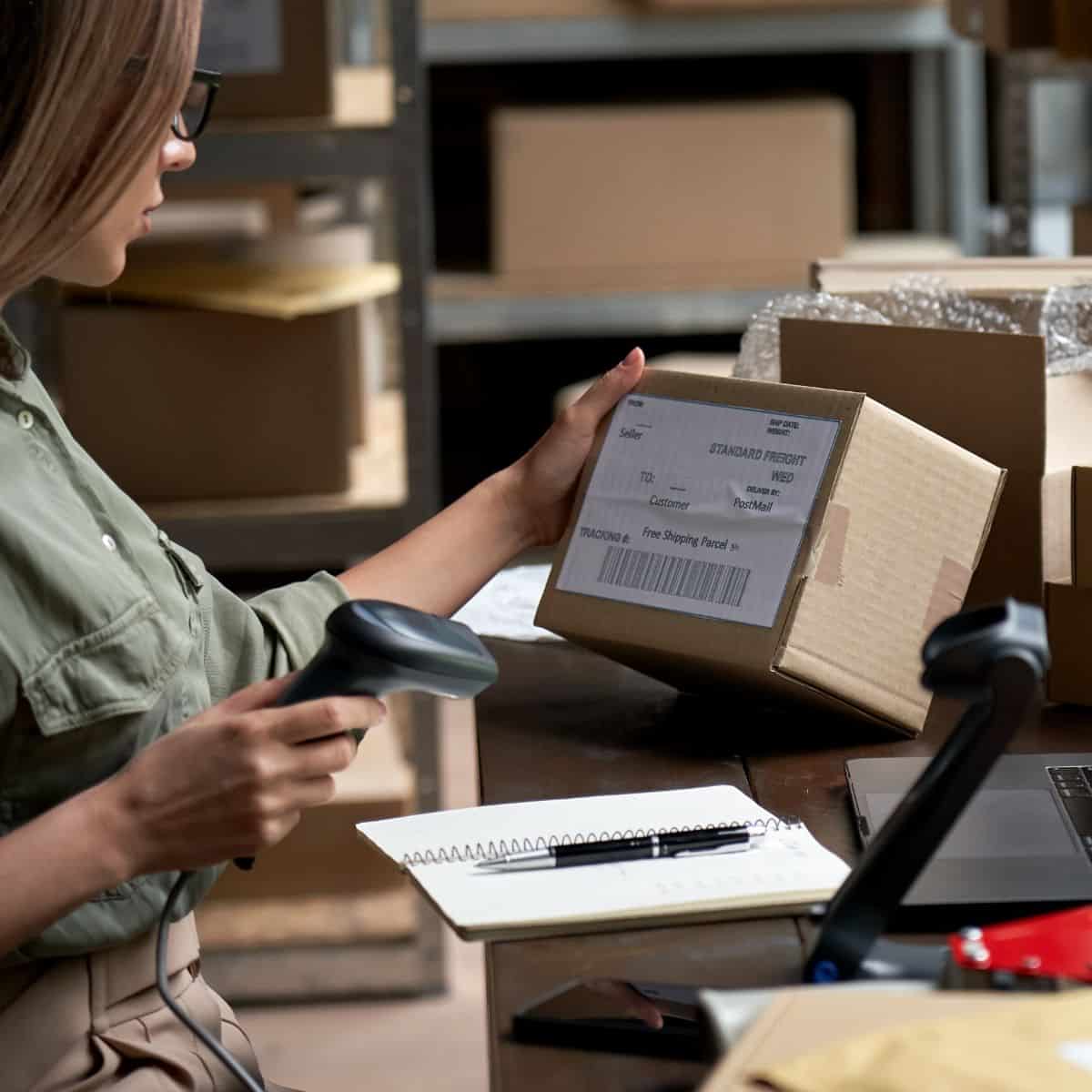 A woman scanning a box label.