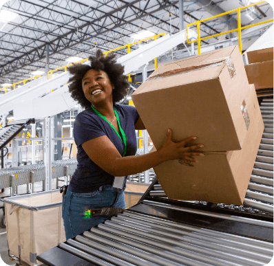 Woman smiling while taking packages off conveyer belt