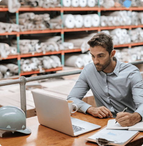 Man working at a desk in a warehouse