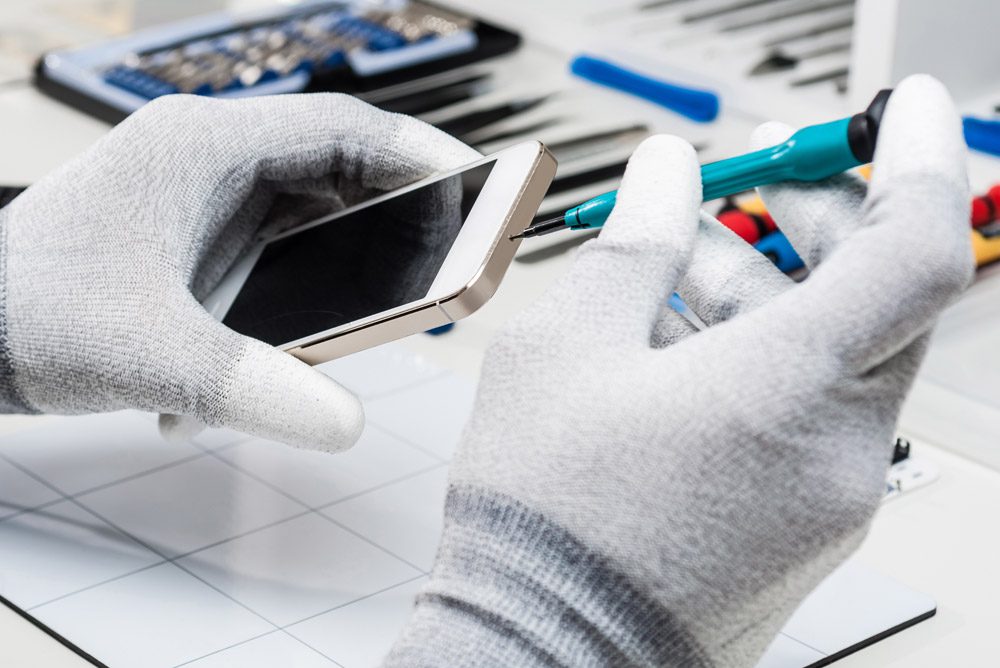 Person working on a cell phone repair