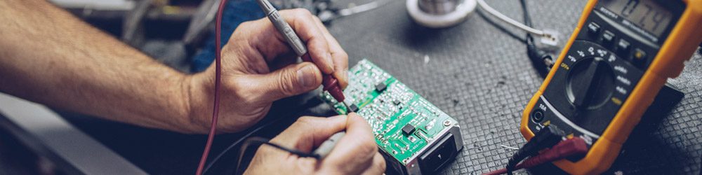 Person working on the electronics of a device