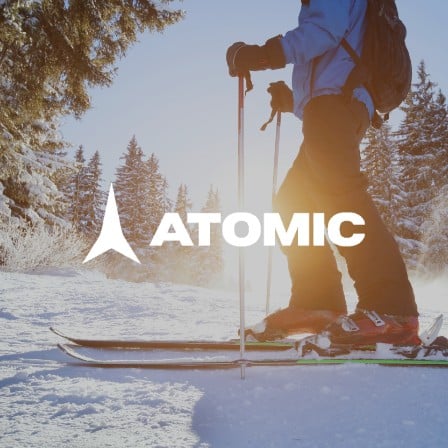 A man skiing with Atomic gear.