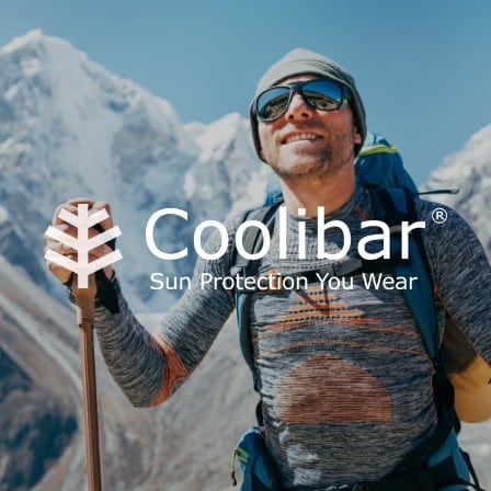 A man hiking while wearing Coolibar sunglasses.