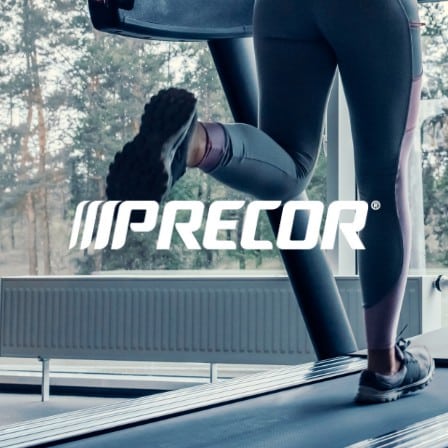Woman running on treadmill with Precor logo