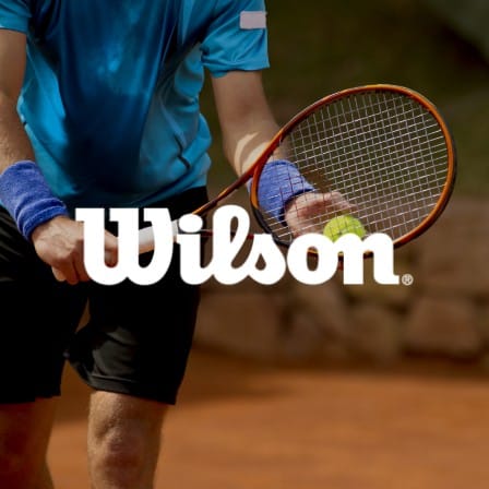 A man playing tennis with the Wilson logo