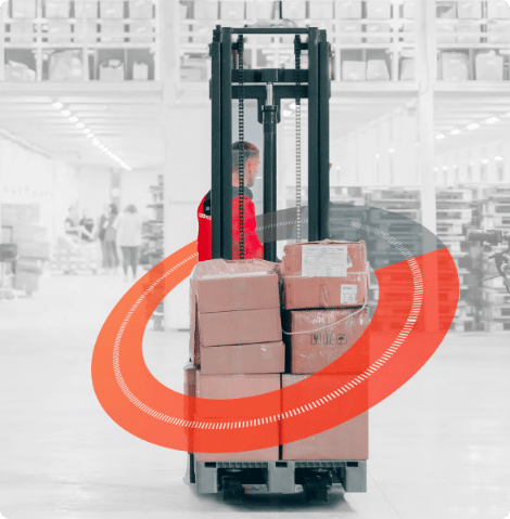 Man operating a forklift in a warehouse with orange circle graphic edit