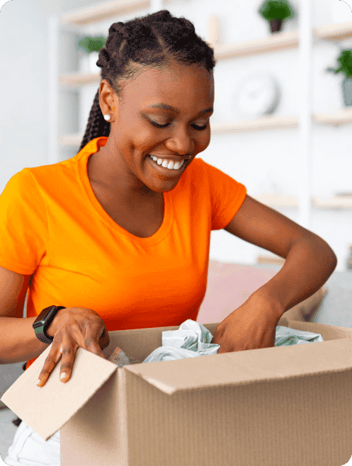 A woman opening a box and smiling