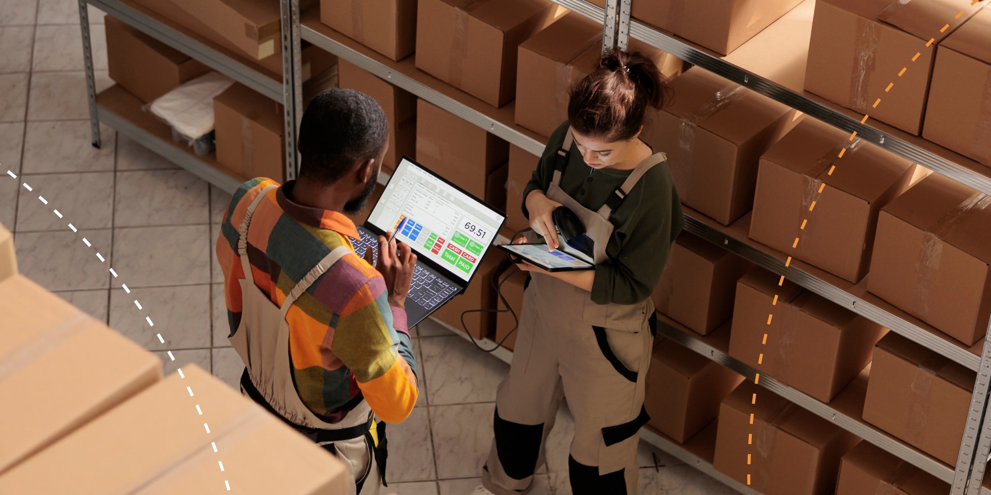 Image of two workers on tablet and laptop in warehouse