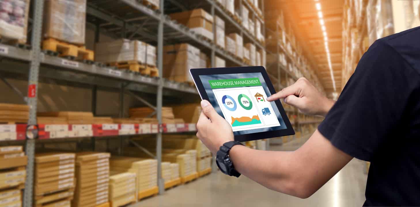 Warehouse Employee Manages Inventory with ReverseLogix Solutions on Tablet