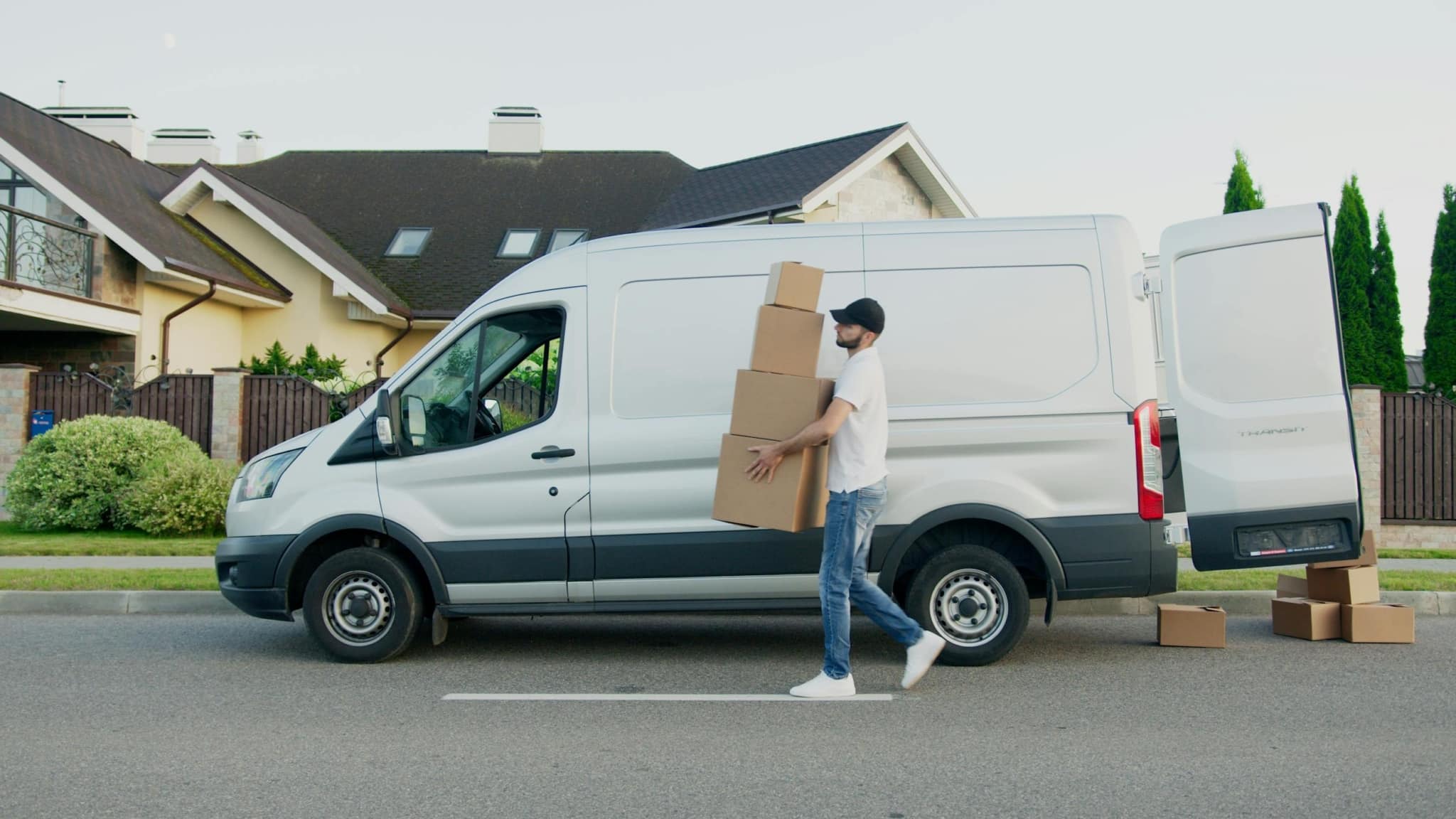 Image of person carrying boxes out of a truck