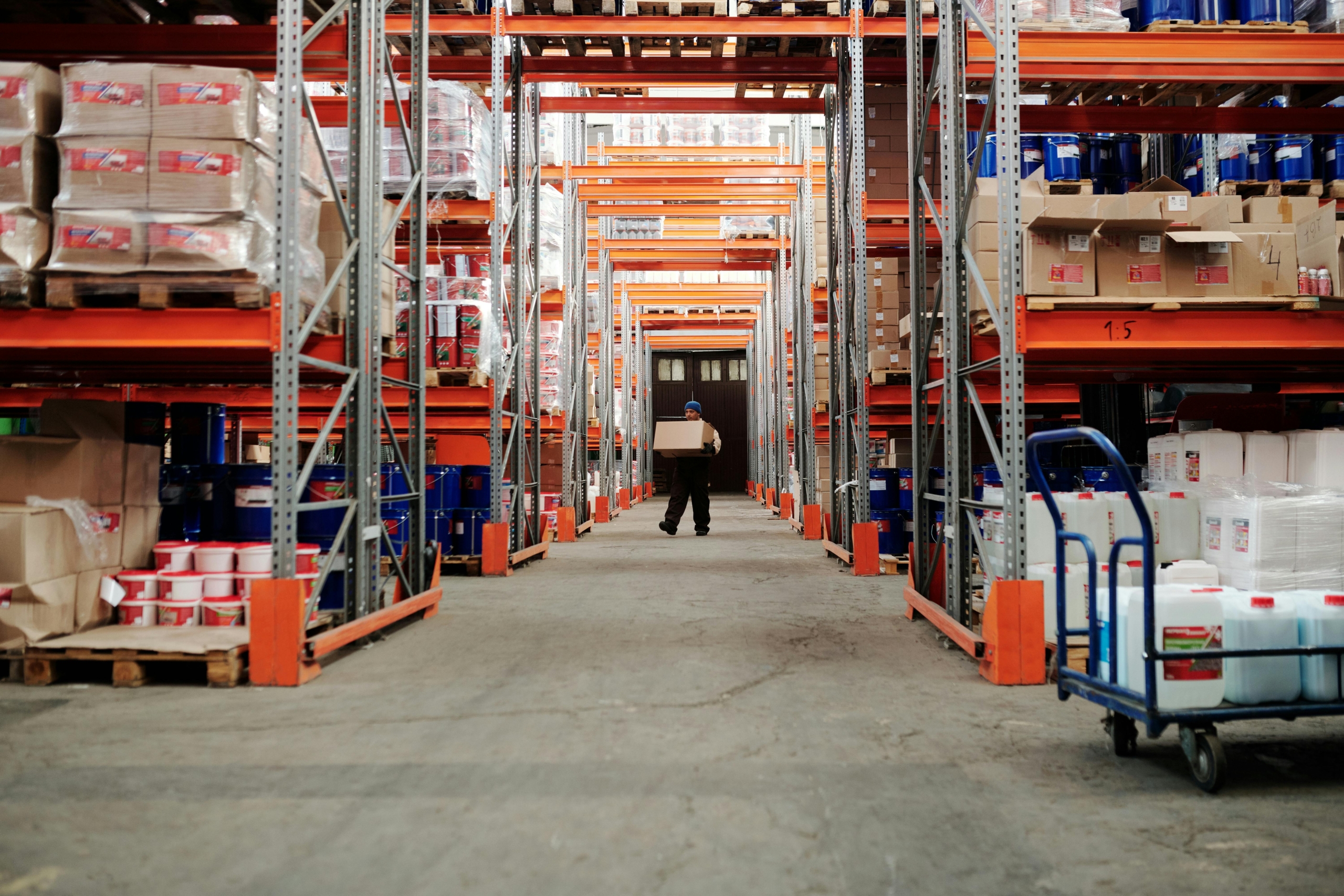 Image of person carrying a box in a warehouse