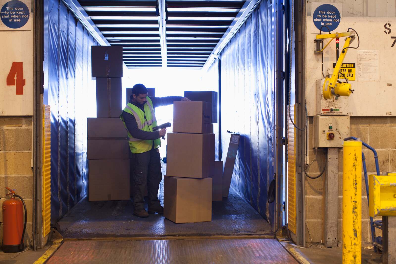 Ecommerce returns management software: warehouse team receiving and scanning returned online orders at a dock
