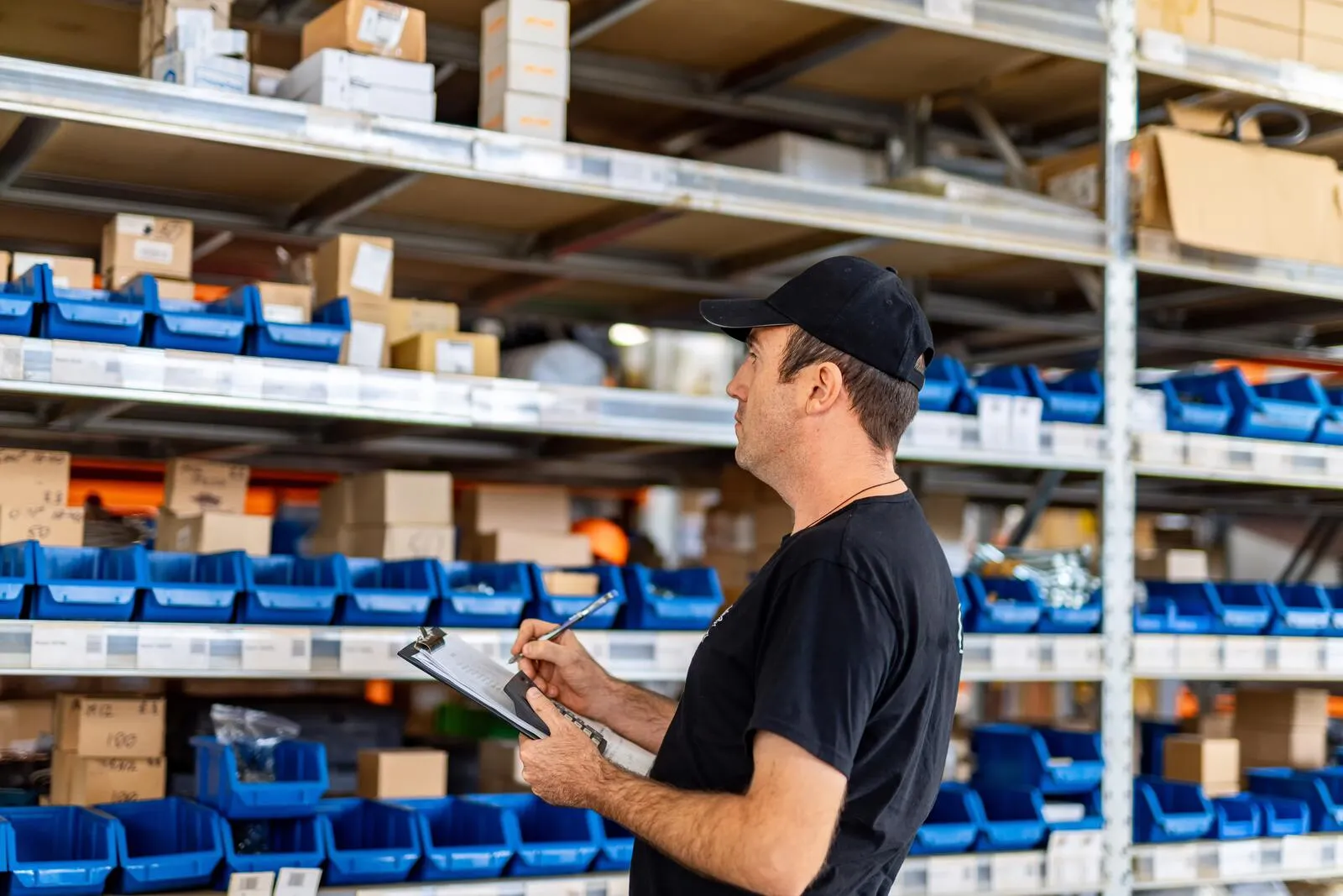 Returned parts on warehouse shelving being graded before restock or resale