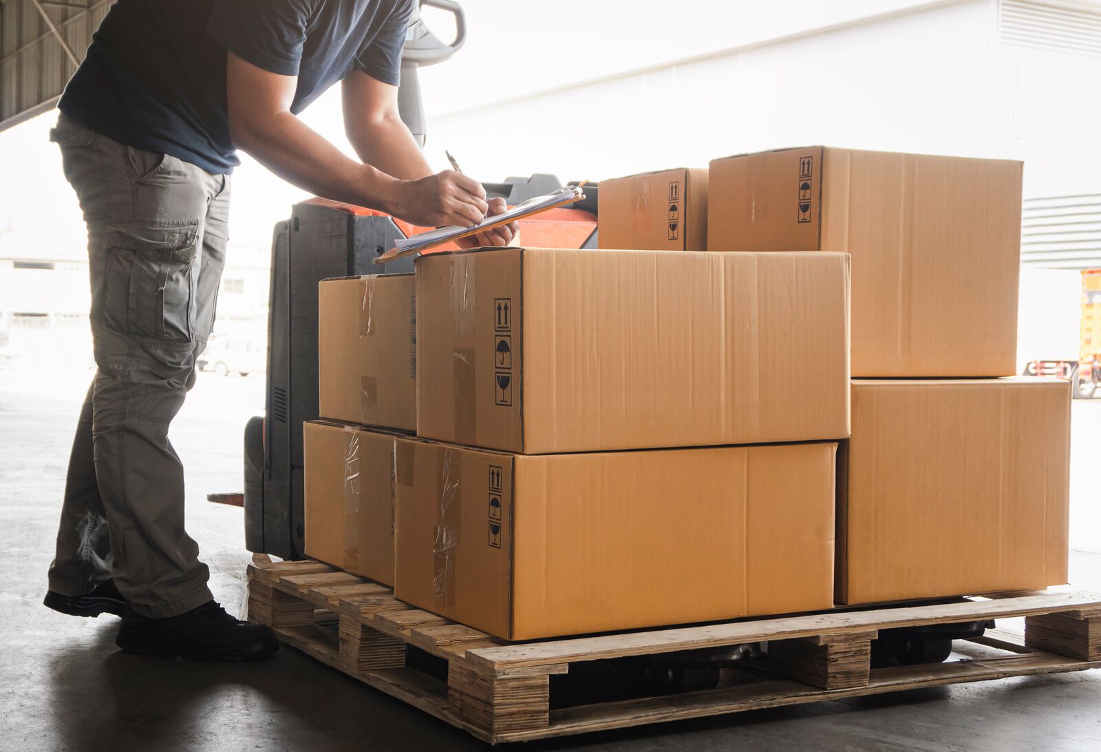 Pallet of mixed returned parts on a receiving dock with no paperwork
