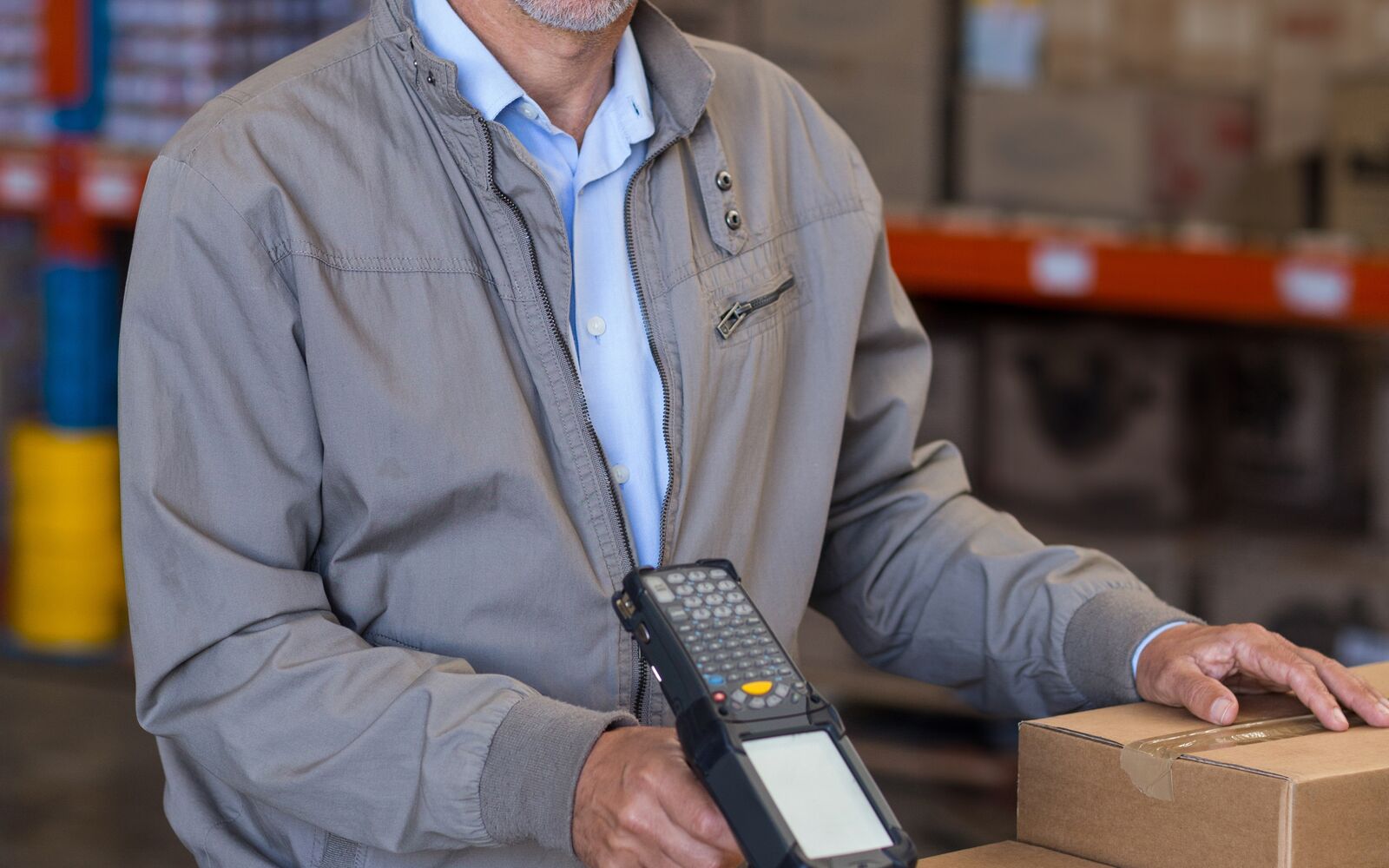 Dynamics 365 returns management integration: warehouse associate scanning a returned carton at a receiving bench