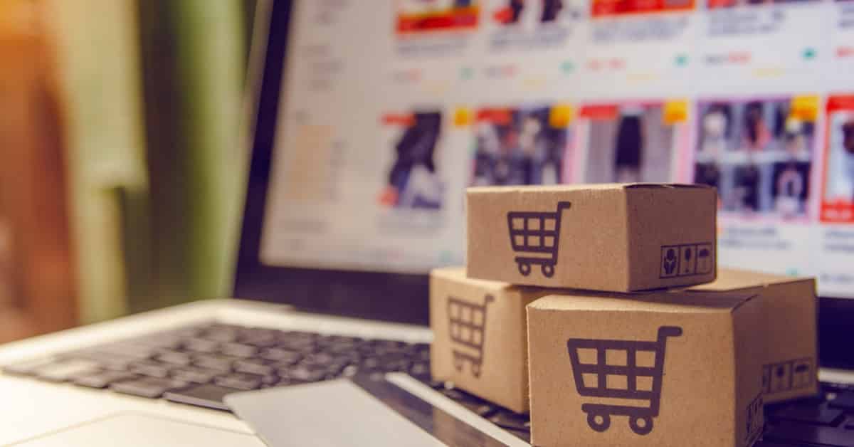 eCommerce online shopping concept with shipping boxes and a computer