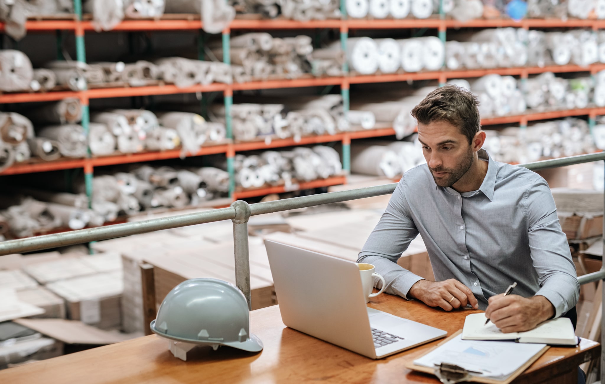 Man working at a desk in a warehouse